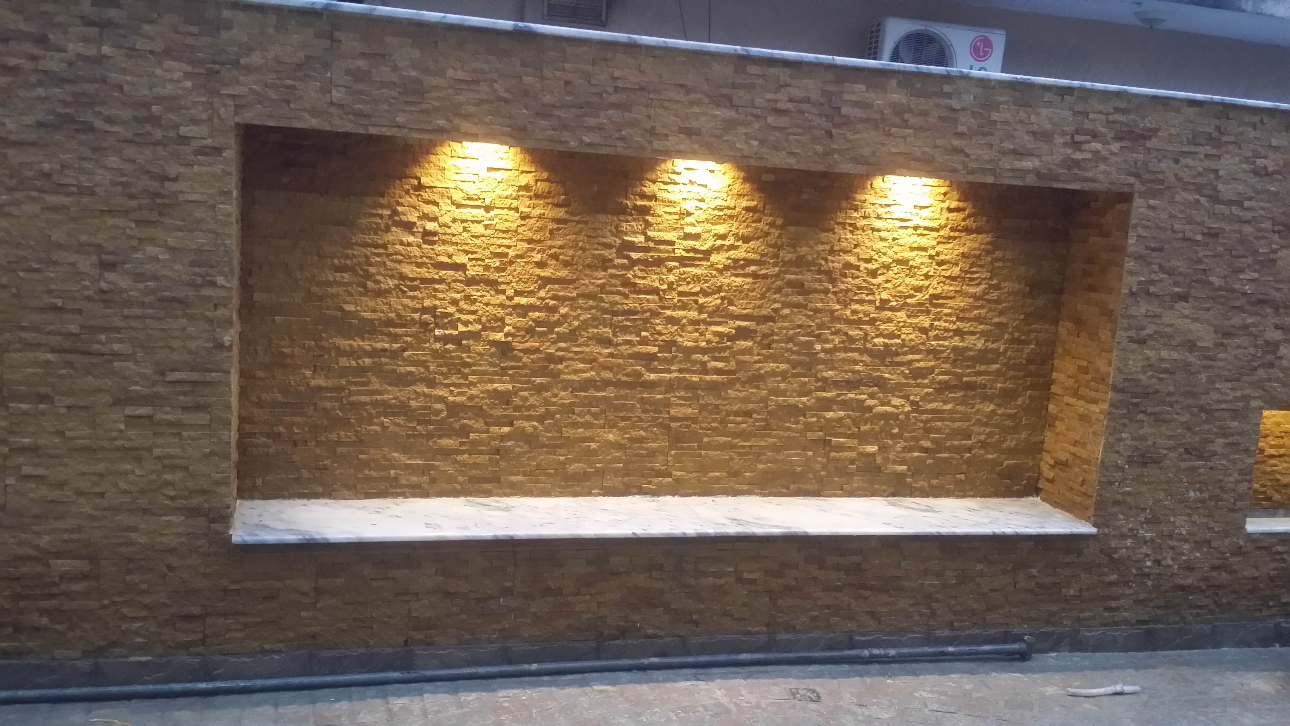 Elevation stone wall panels lit interior